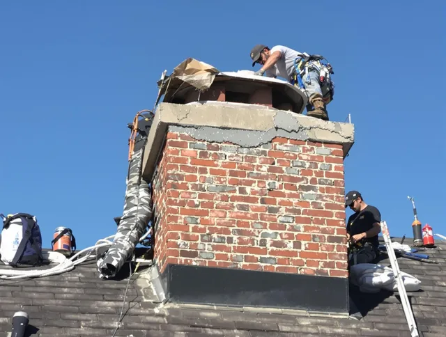 Groton Chimney Sweep installing a custom chimney crown in Groton, CT